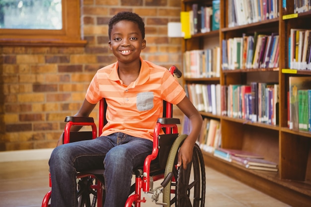 [freepicdownloader.com]-portrait-boy-sitting-wheelchair-library-normal